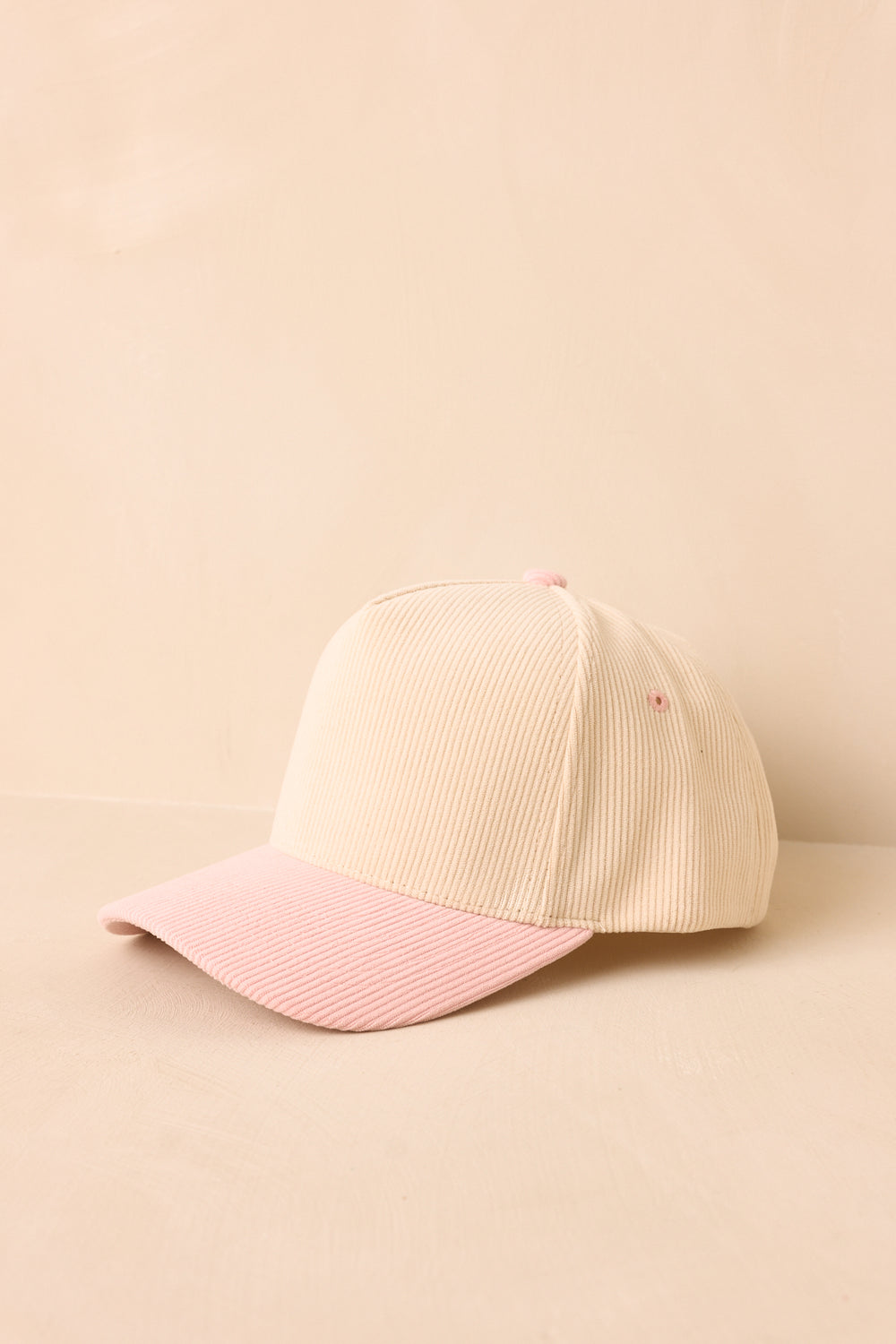 Beige-And-Pink-Baseball-Cap-On-A-Beige-Background