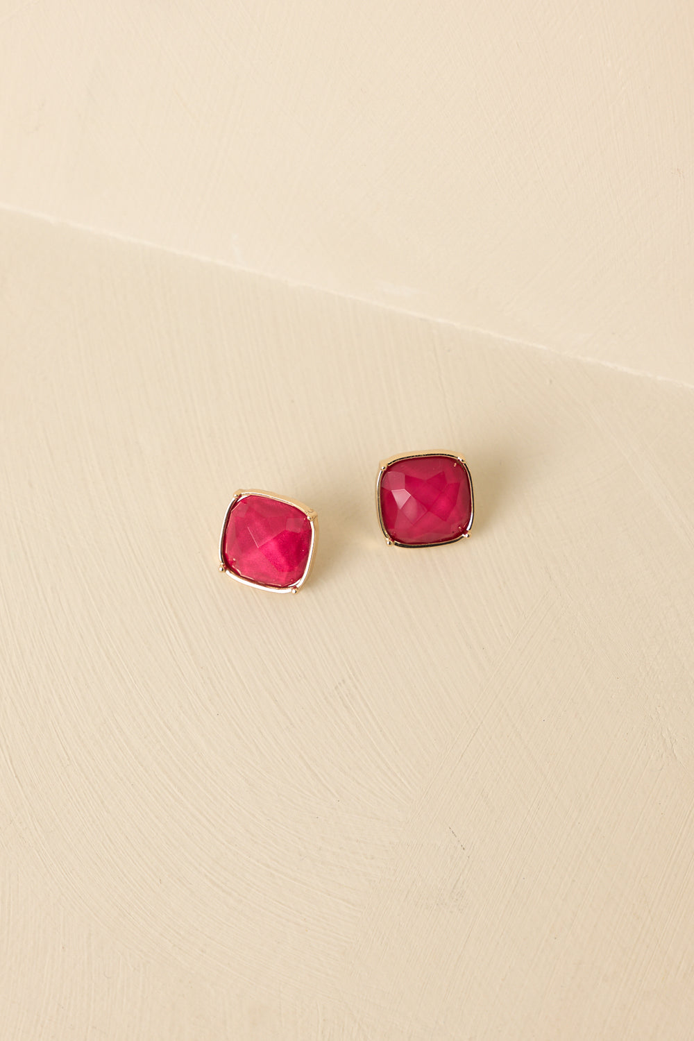 Front-View-Of-Cranberry-Red-Stud-Earrings-Emphasizing-Gemstones