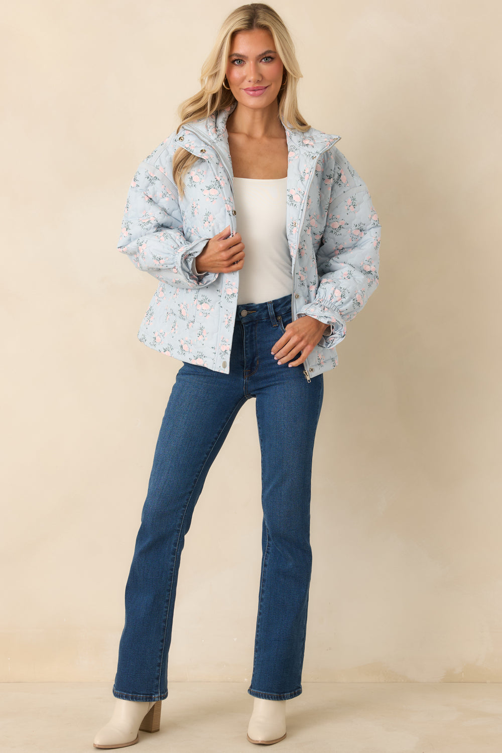 Light-Blue-Quilted-Jacket-With-Scattered-Pink-Flowers-And-Green-Foliage