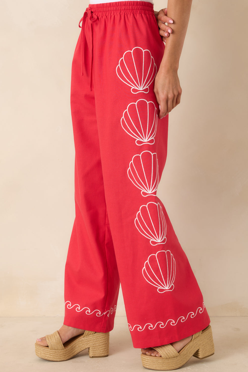 Shell-Embroidery-And-Contrast-Wave-Trim-On-Red-Fabric